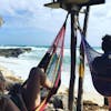 Relaxing in a hammock down by the sea.