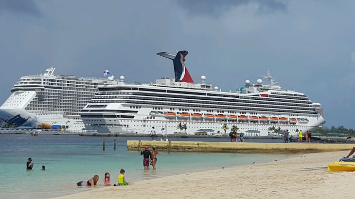 Nassau, Bahamas - Nassau next to Norwegian Escape.  Carnival a small boat next to Escape