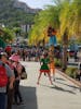 Stilt man in port near taxi stand