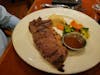 Bland steak dinner with dollop of potatos