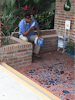 Man reading a Spanish language gospel tract (that I gave him) outside at the glass blowing shop