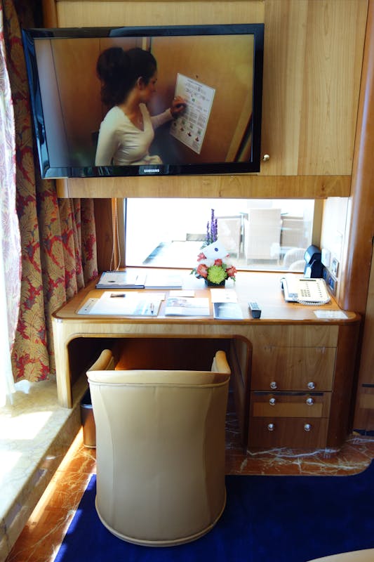Work Desk with window over looking balcony on the Pinnacle Suite, Cabin 7001 - Zaandam