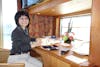 Wife at Desk with Window Overlooking Balcony on Pinnacle Suite, Cabin 7001