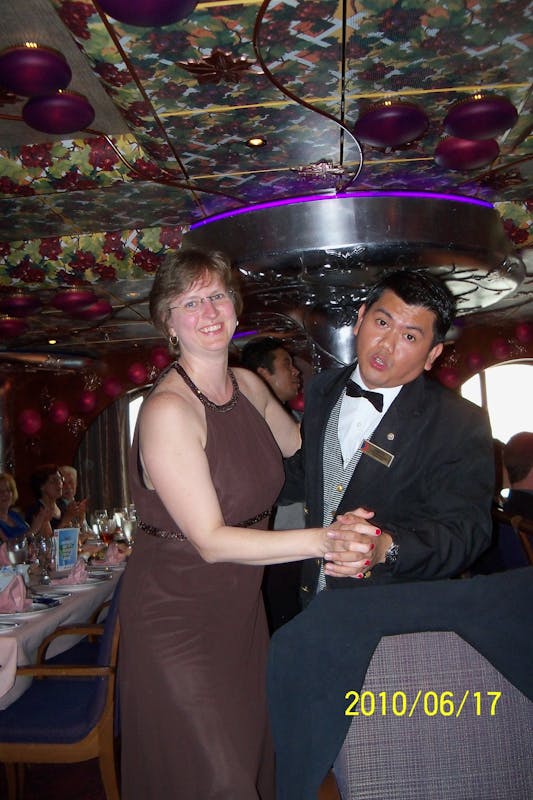 Me dancing with our waiter.  - Carnival Miracle