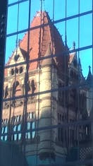 New highrise with reflection of beautiful church across the Copley square area.