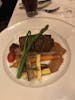 Veal medallions in motel sauce with twice baked potato cakes and seasoned vegetables