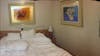 Part of a Panoramic photo. Our EXTREMELY comfortable bed before Francisco made it later that day. We always got new sheets and pillow cases and the art work in the room was beautiful. 