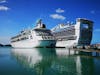 Ship docked next to larger Carnival Ship 