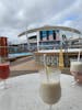 Celebratory pina colada on deck 11 pool bar on day 1 after boarding by 10:35