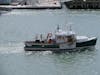 Lobster boat in Boston harbour with a seagull hitch hiking on the stern