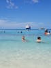 Swimming in the beautiful ocean with our ship Carnival Liberty in the background.