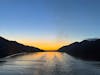 The view from the Poker Room in the Conference Center of the Quantum of the the seas while leaving Juneau at sunset