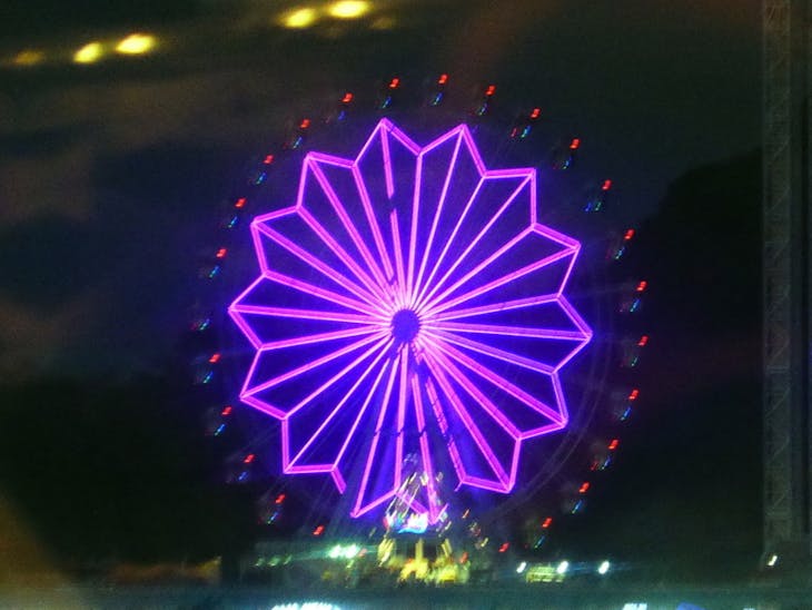 Ferris Wheel seen from our swhip lit up at night - Amsterdam