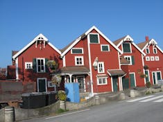 Typical small boat harbor scene with homes in southern Norway