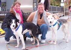 Amy & Mike with two of Iditarod champion Libby Riddles' sled dogs.